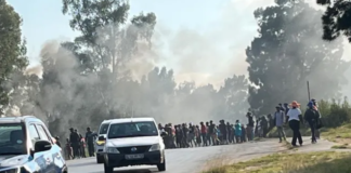 Burning tyres and blocked roads: Transport operators stop work over months of unpaid fees